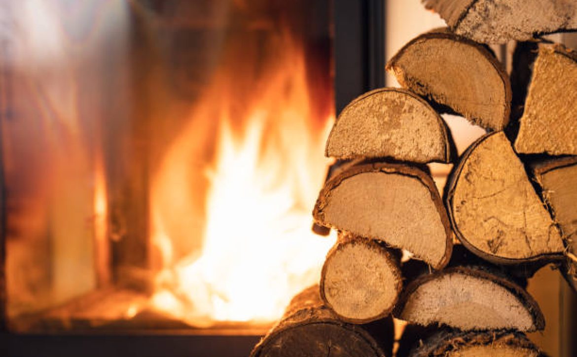 Firewood stack in front of stove.